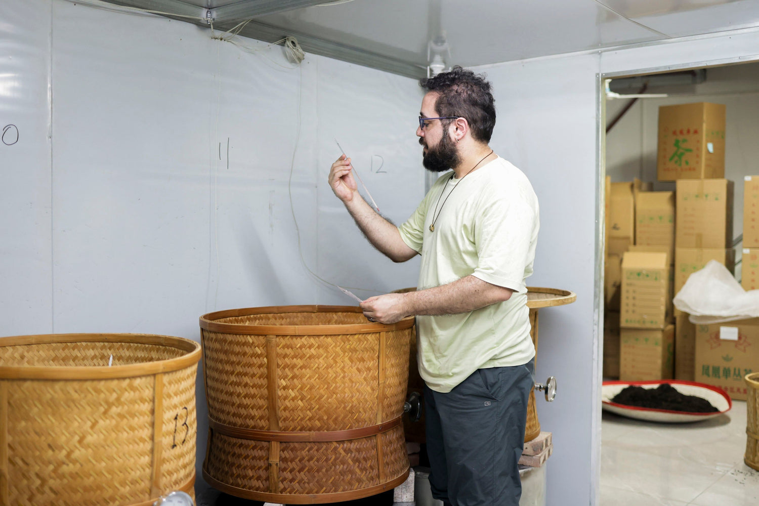 Nadi Biran is checking the progress of tea roasting, Chaozhou, Guangdong