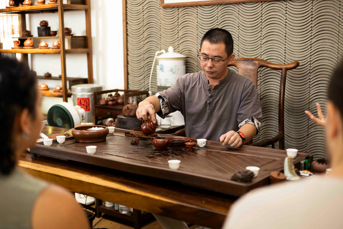 wuyi yan cha tea maker in a tea tasting session using Chaozhou clay pot